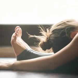c0bc41b5-5f44-42ac-9918-ed7b047f5762-woman-doing-yoga-forward-bend-feet.jpg